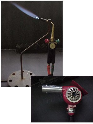 A lit handheld torch and electric heatgun composite